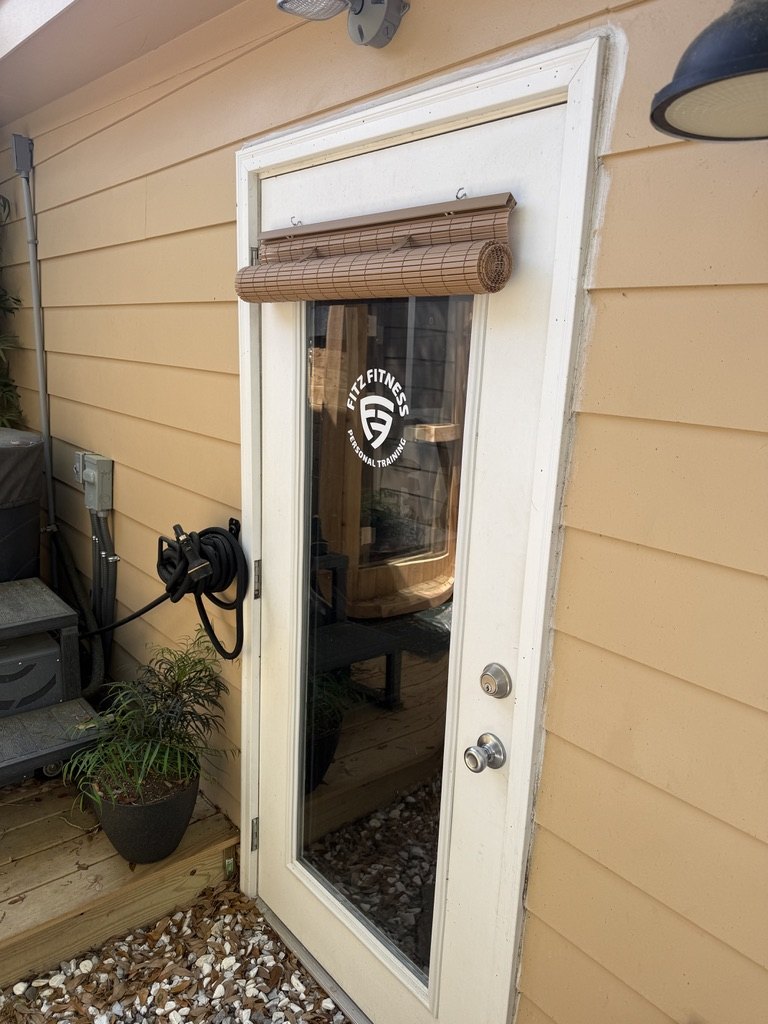 The branded glass door of the outdoor sauna at Fitz Fitness, Johns Island